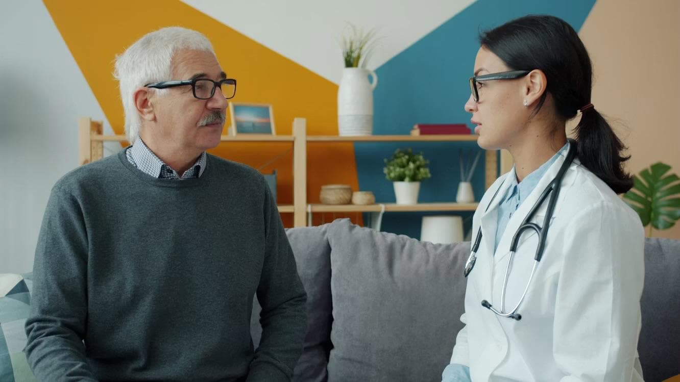 A clinician speaking with a patient in a calm care conversation.